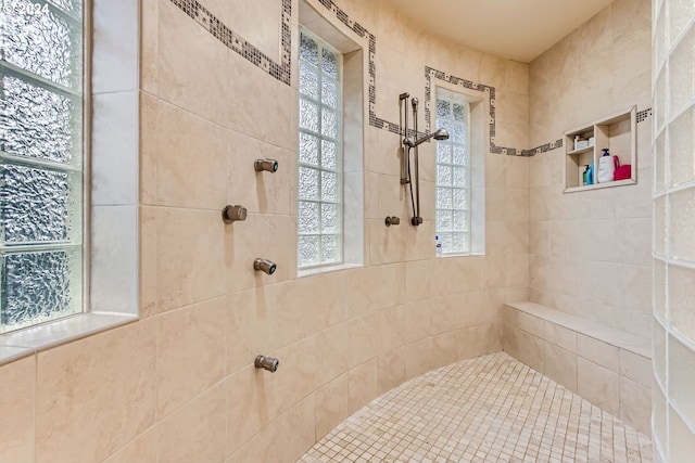 bathroom with a tile shower