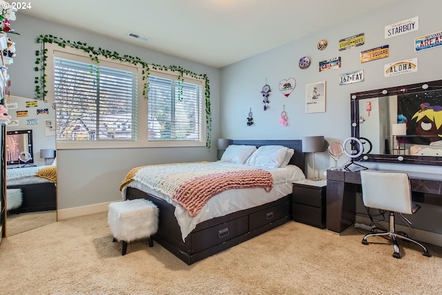 bedroom with light carpet and multiple windows