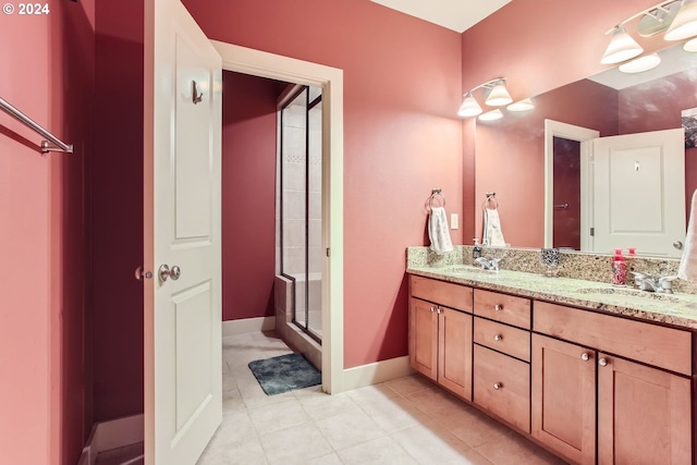 bathroom featuring tile patterned floors, vanity, and an enclosed shower