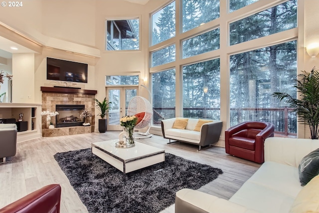 13829 SE Claremont St, Happy Valley, OR 97086 - living room featuring a high ceiling, wood finished floors, and a tile fireplace