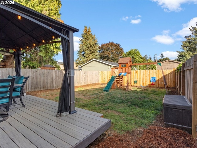 wooden terrace with a gazebo, a playground, and a lawn