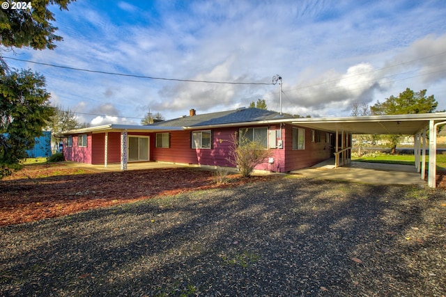 view of front of property featuring a carport