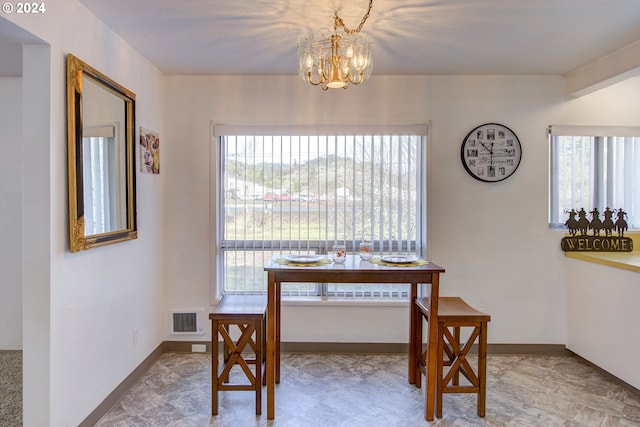 dining room with a healthy amount of sunlight and an inviting chandelier