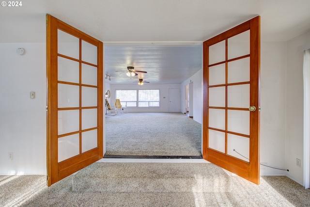 spare room with ceiling fan, carpet floors, and french doors