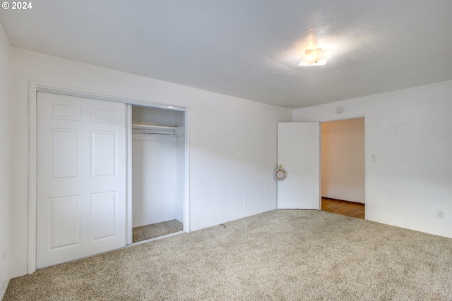 unfurnished bedroom with carpet floors and a closet