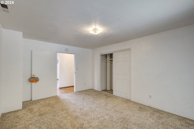 unfurnished bedroom with carpet floors and a closet