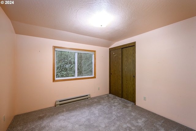 unfurnished bedroom featuring a textured ceiling, carpet floors, a closet, and a baseboard heating unit