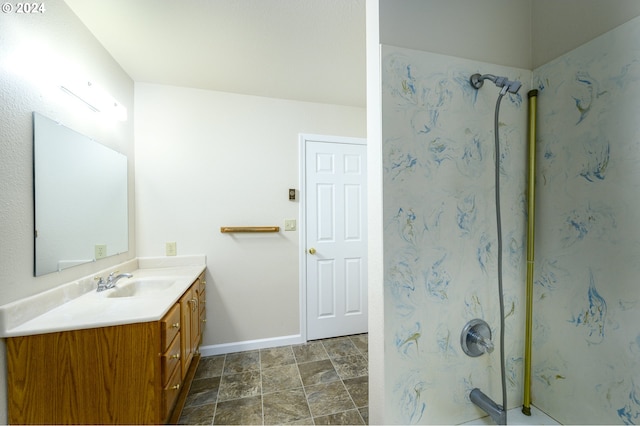 bathroom with a shower and vanity