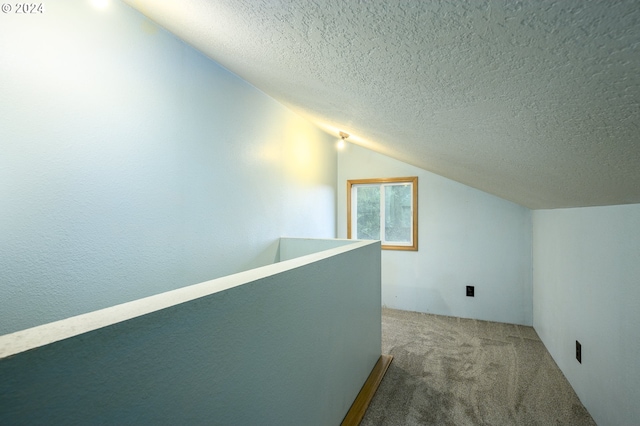 bonus room featuring carpet flooring, a textured ceiling, and vaulted ceiling