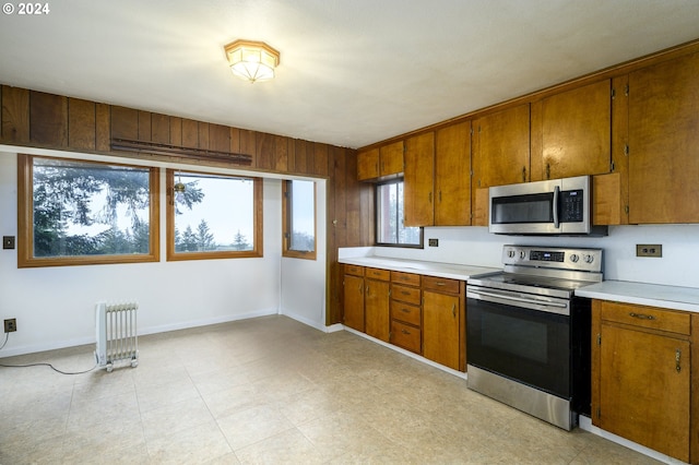 kitchen featuring radiator heating unit and stainless steel appliances