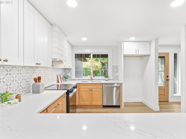 kitchen featuring white cabinetry, sink, stainless steel appliances, backsplash, and light brown cabinetry