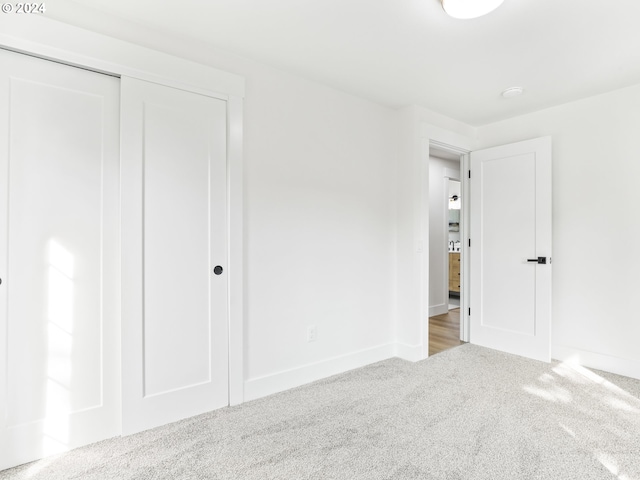 unfurnished bedroom featuring a closet and carpet