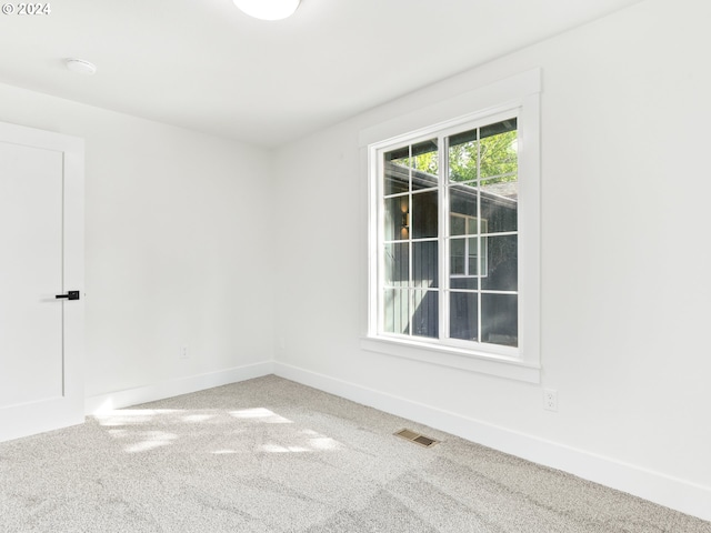 unfurnished room featuring carpet