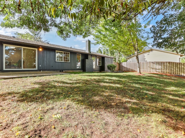 rear view of house with a yard