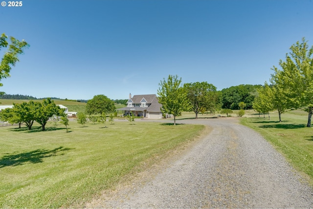 view of street featuring a rural view and gravel driveway