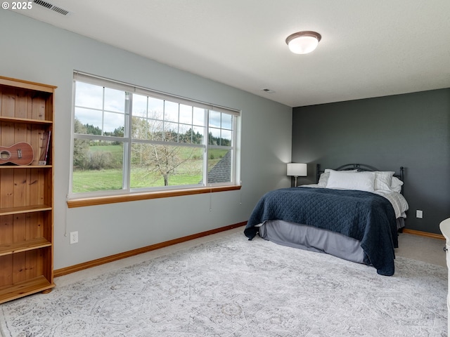 carpeted bedroom featuring visible vents, multiple windows, and baseboards