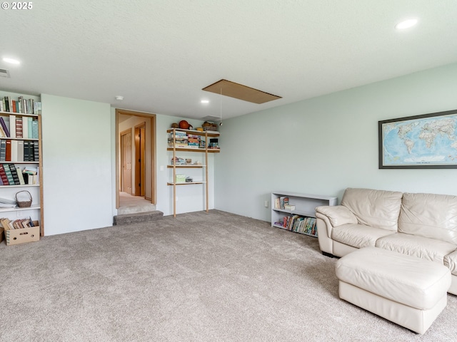carpeted living area featuring attic access, visible vents, and recessed lighting