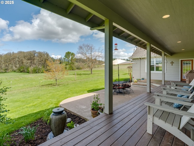 deck with a patio and a lawn