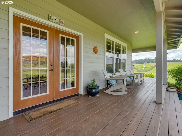 deck featuring a porch and french doors