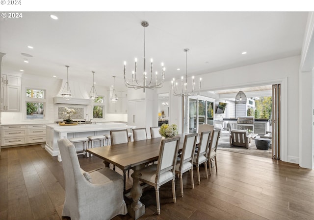 dining space with dark wood-type flooring, a chandelier, and recessed lighting