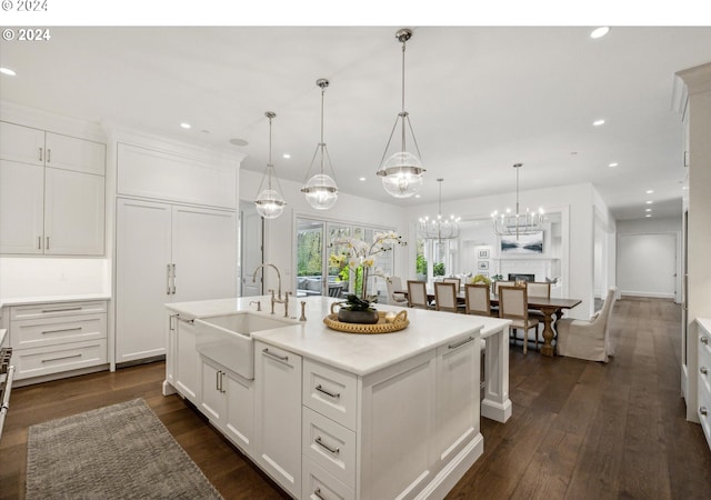 kitchen with recessed lighting, white cabinets, and a sink