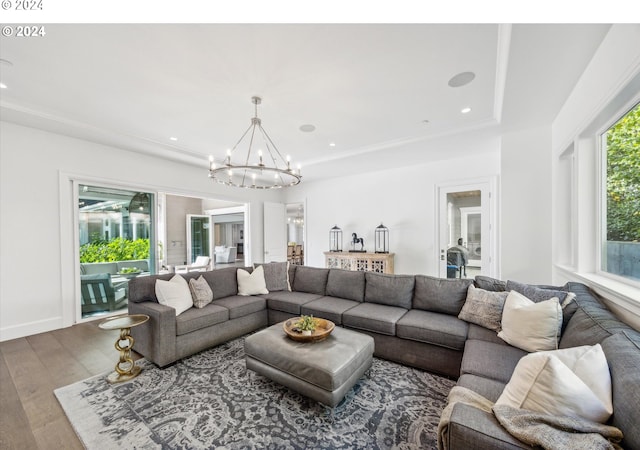 living area featuring hardwood / wood-style floors, a notable chandelier, and recessed lighting