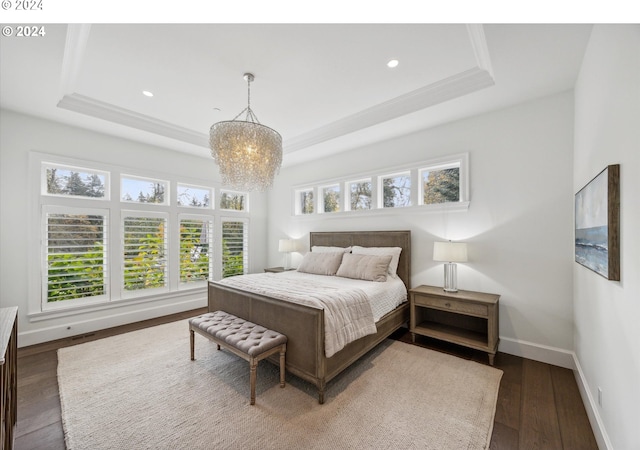 bedroom with recessed lighting, a notable chandelier, a tray ceiling, baseboards, and wood finished floors