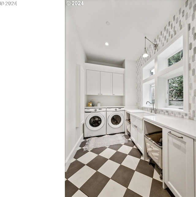 clothes washing area featuring recessed lighting, separate washer and dryer, cabinet space, dark floors, and a sink