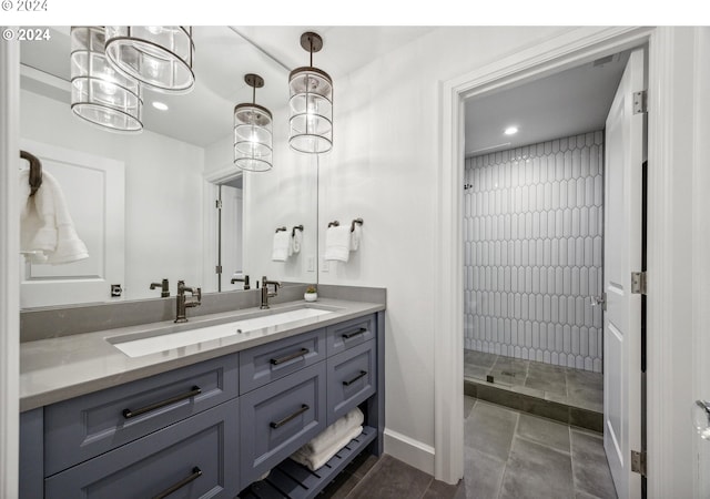 full bathroom featuring recessed lighting, vanity, tile patterned floors, a tile shower, and baseboards