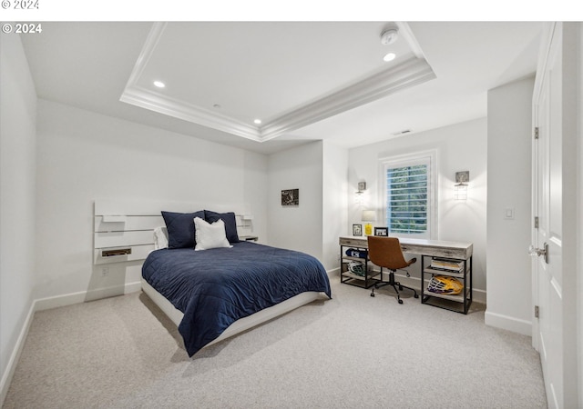 carpeted bedroom with a raised ceiling and crown molding