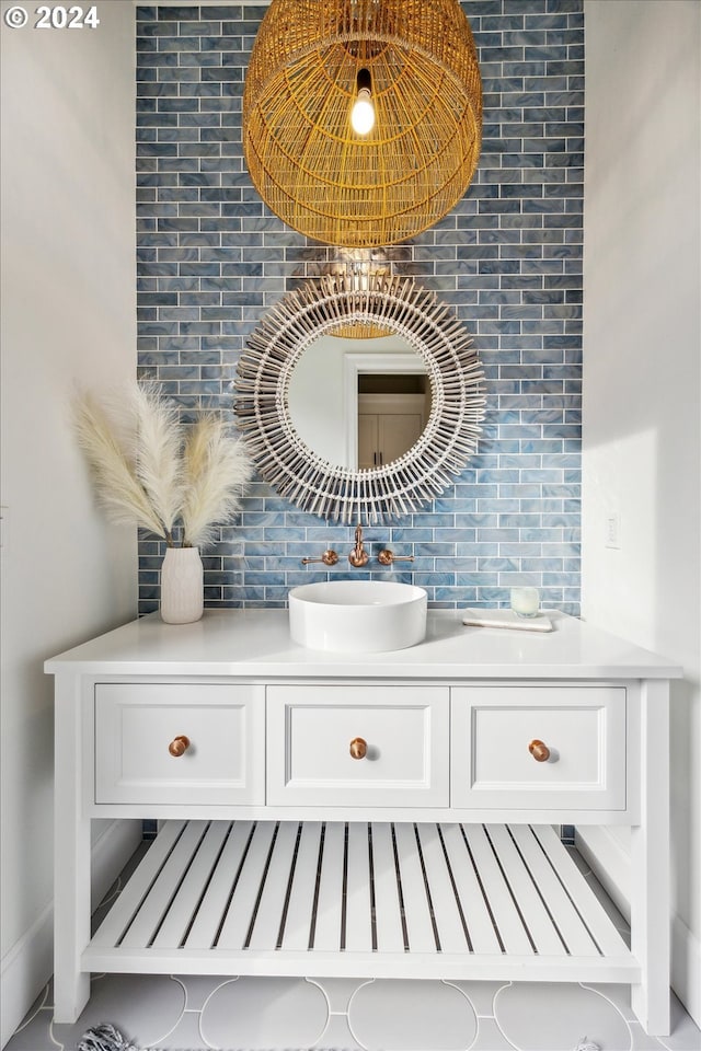 details featuring vanity and tasteful backsplash