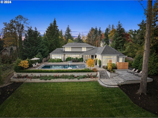 rear view of house featuring a yard and a patio area