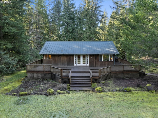 20480 E Lolo Pass Rd, Rhododendron, OR 97049 - back of house with metal roof, a view of trees, a deck, and a lawn
