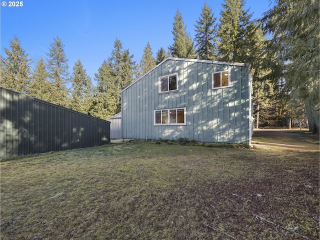 view of side of home featuring a lawn