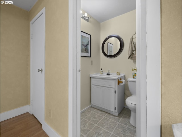 bathroom featuring toilet, vanity, and tile patterned floors