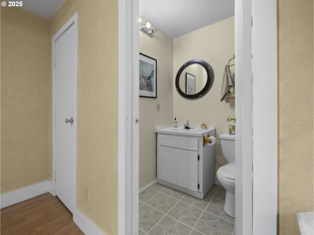 20480 E Lolo Pass Rd, Rhododendron, OR 97049 - bathroom with vanity, toilet, wood finished floors, and baseboards