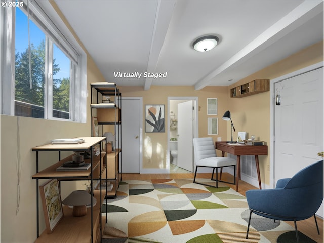 interior space with light wood-type flooring and beamed ceiling