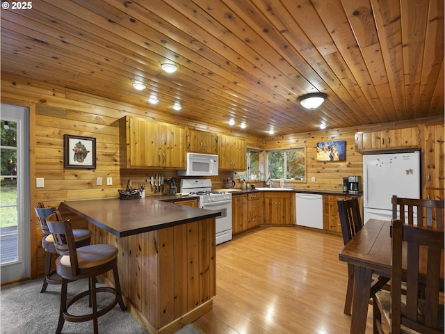 kitchen featuring sink, white appliances, light hardwood / wood-style floors, kitchen peninsula, and wood ceiling