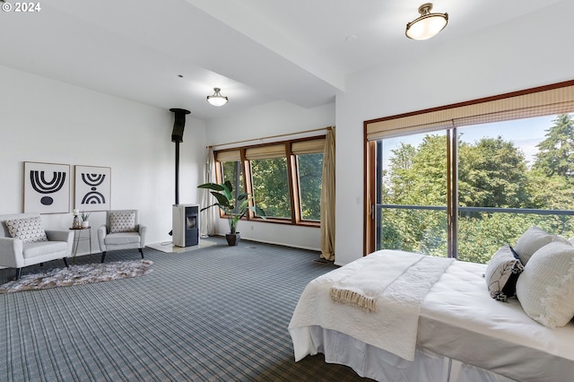 bedroom with a wood stove and carpet