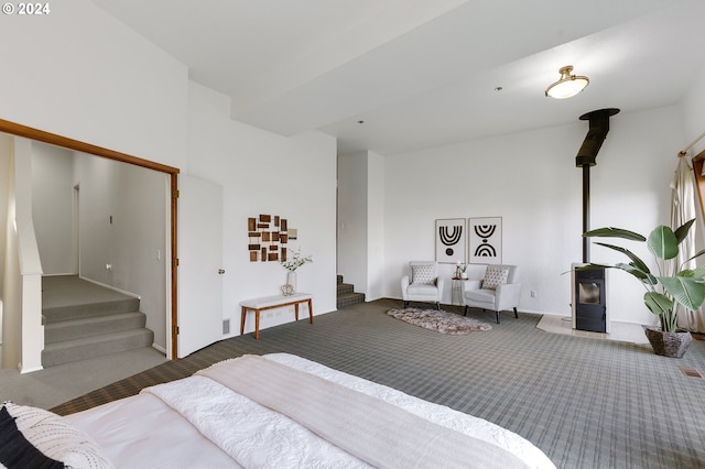 bedroom with a wood stove and carpet