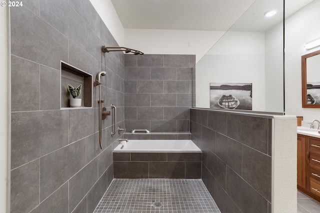 bathroom with vanity, tiled bath, and tile patterned flooring