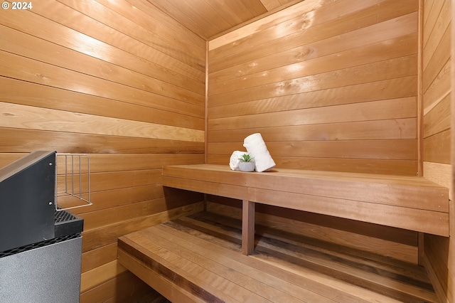 view of sauna featuring wood walls