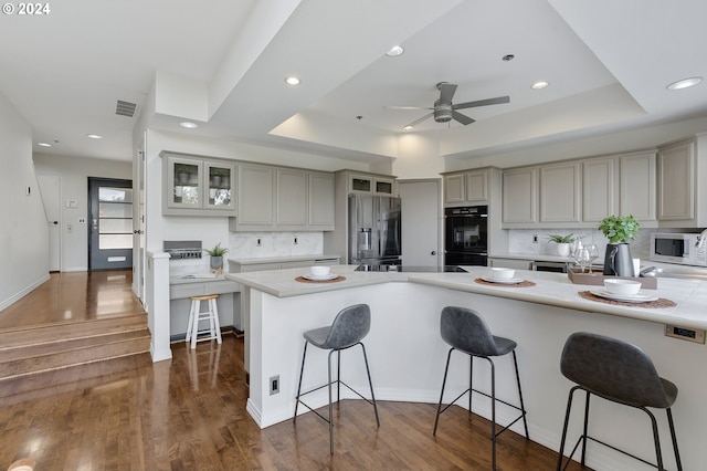 kitchen with dark hardwood / wood-style floors, tasteful backsplash, and stainless steel refrigerator with ice dispenser