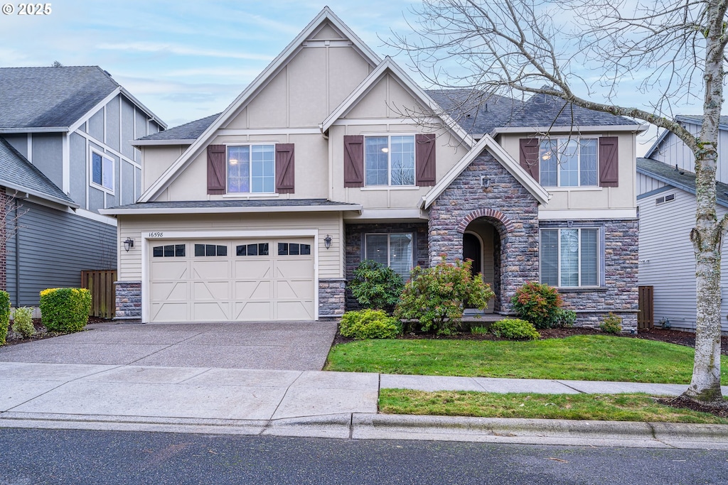 tudor-style house with a front yard and a garage