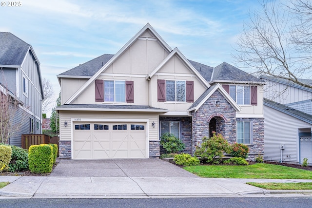 english style home featuring a front yard and a garage