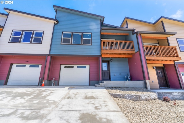 multi unit property featuring a balcony and a garage