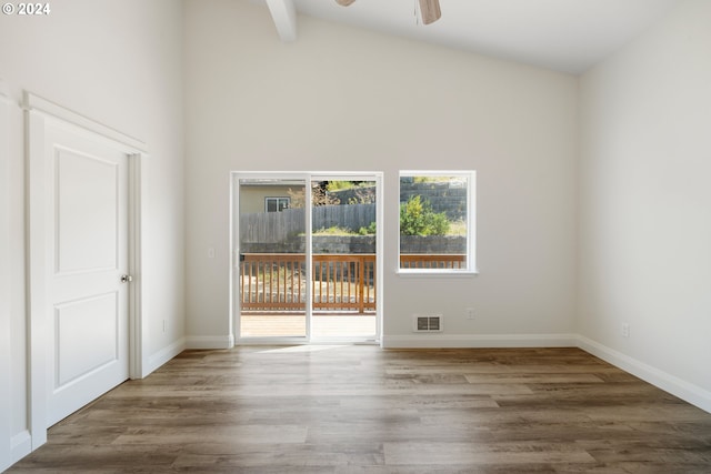 empty room featuring ceiling fan, beamed ceiling, wood-type flooring, and high vaulted ceiling