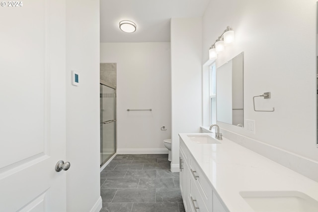 bathroom with tile patterned flooring, vanity, an enclosed shower, and toilet