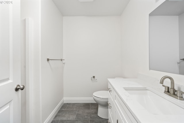 bathroom featuring tile patterned floors, vanity, and toilet