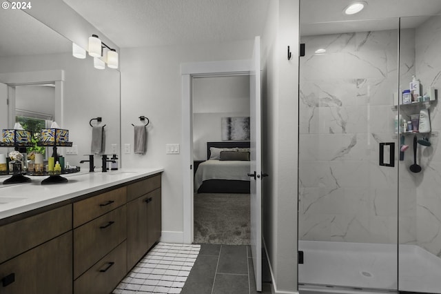 bathroom featuring tile patterned flooring, vanity, an enclosed shower, and a textured ceiling